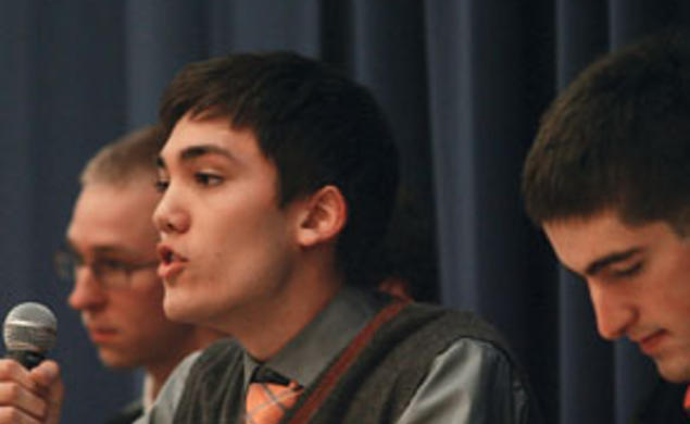 Christian Fong ’14 critiques Occupy Wall Street during  a Jan. 13 debate. Listening are Kevin Henneck ’13, left, of the anti-Occupy side and Peter Favaloro ’12, right, of the pro-Occupy team.