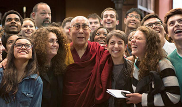 Students look up for a photo with the Dalai Lama in Chancellor Green.