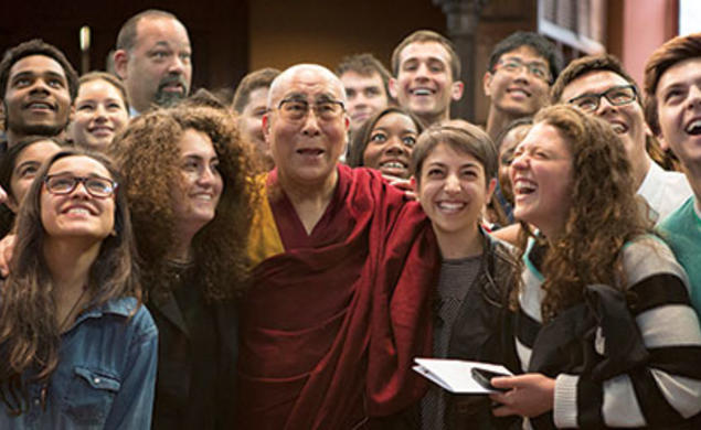 Students look up for a photo with the Dalai Lama in Chancellor Green.