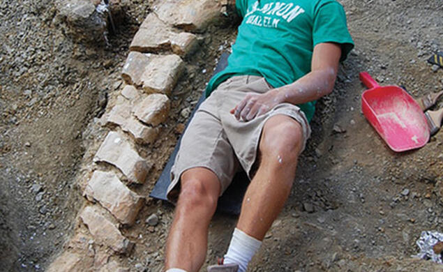 Evan Saitta ’14 at the site of a fossil dig in Montana.