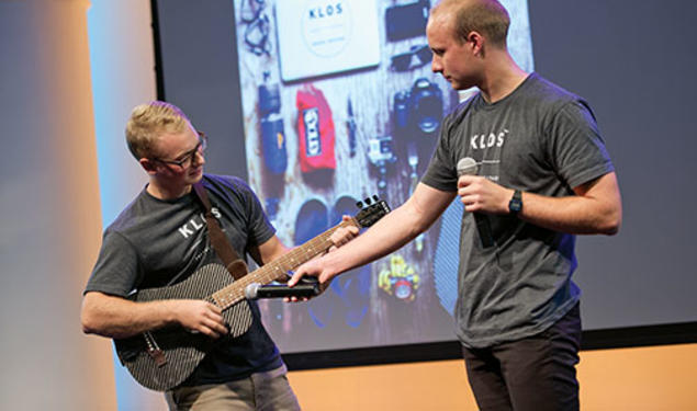 Adam Klosowiak ’15, left, demonstrates a KLOS travel guitar with Jake Sheffield, also of KLOS.