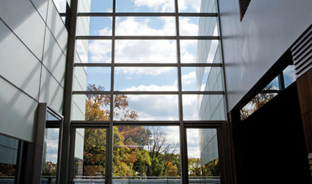 The view south from the two-story atrium of the neuroscience/psychology building; an outdoor patio is beyond the glass wall.