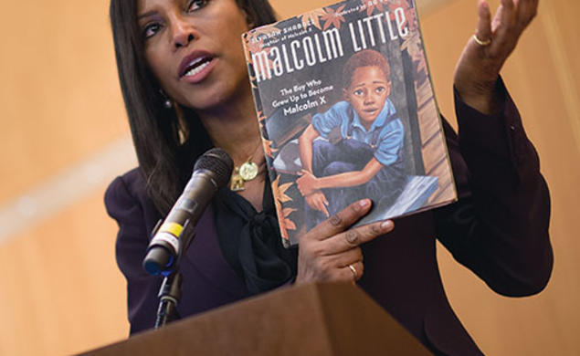 Ilyasah Shabazz with a book she wrote about her father, Malcolm X, as a child