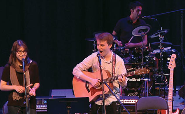 Performing “Death by Mall” during a concert by student songwriters are, from left, Sydney King ’17, Charlie Baker ’17, and Arjun Dube ’15 on drums.