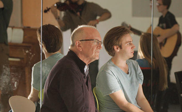 Director John Doyle and Christopher Beard ’14 watch student actor-musicians perform.