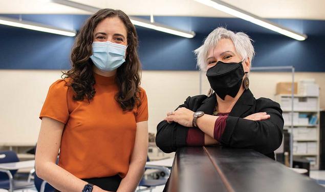 This is a photo of Natalka Pavlovsky *01, right, and Sophie Brady in a classroom..