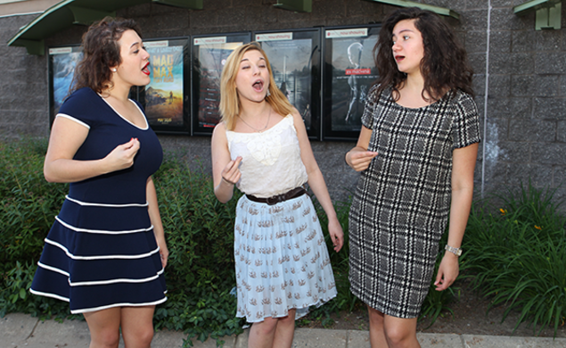 From left, Wildcats a cappella members Kat Giordano â18, Arianna Lanz â17, and Samone Blair â18 review Pitch Perfect 2 with PAW senior writer Mark F. Bernstein â83. (Beverly Schaefer)