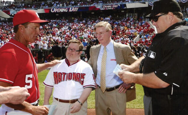 Baseball fan Jon Will, pictured with his father, gives the Washington Nationals’ lineup card to umpires on Opening Day in 2010.