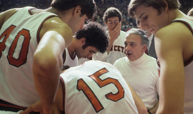 On Nov. 26, 1977, Princeton head coach Pete Carril huddles with his team on the sidelines during a game against Colgate at Jadwin Gymnasium. 