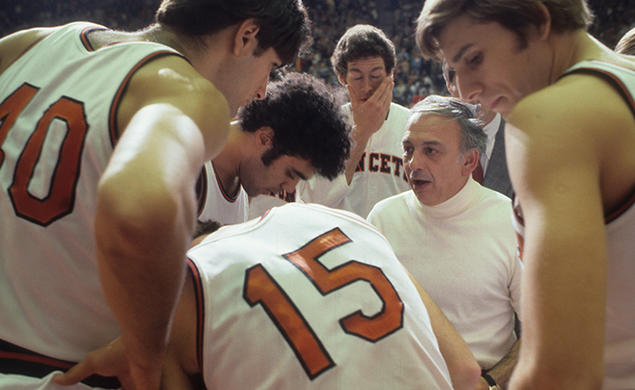 On Nov. 26, 1977, Princeton head coach Pete Carril huddles with his team on the sidelines during a game against Colgate at Jadwin Gymnasium. 