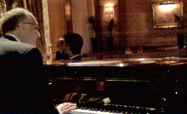 A cellphone photo captures Thomas Schiavoni ’72’s moment at the Steinway of the Bar Vendome in the Hotel Ritz in Paris. 