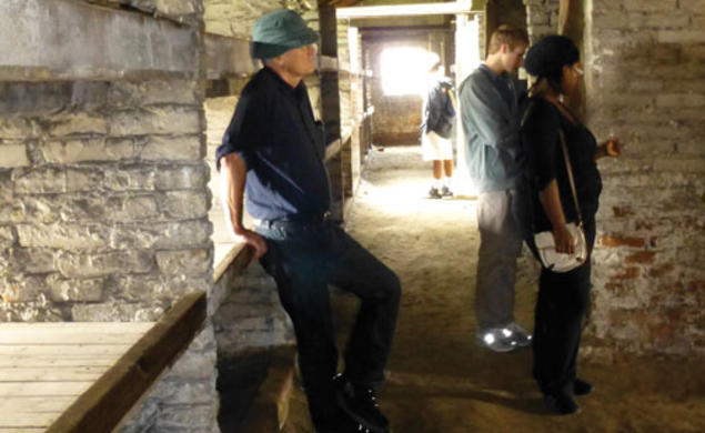 Students visit Birkenau, part of the Nazis’ Auschwitz concentration camp. From left, professor Jan Gross, Eric Silberman ’13, and Lydia Demissachew ’15 examine the barracks where Jewish prisoners were housed. 