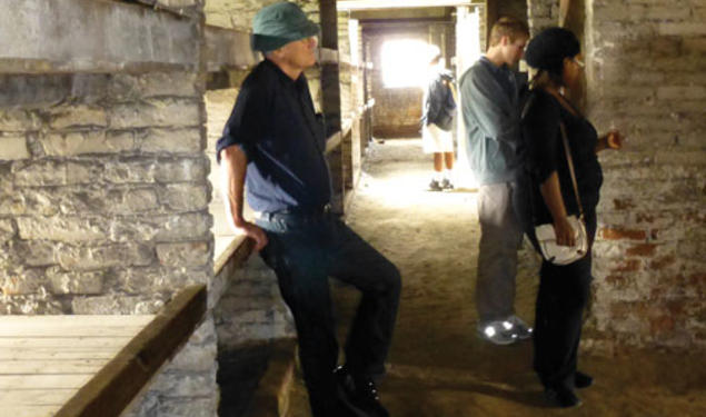 Students visit Birkenau, part of the Nazis’ Auschwitz concentration camp. From left, professor Jan Gross, Eric Silberman ’13, and Lydia Demissachew ’15 examine the barracks where Jewish prisoners were housed. 