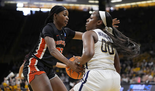 Madison St. Rose ’24, left, defends West Virginia guard Jayla Hemingway, with ball