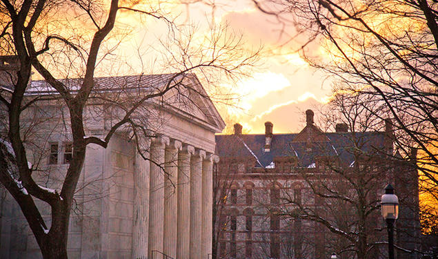 The sun rises over Princeton University campus buildings in 2014.