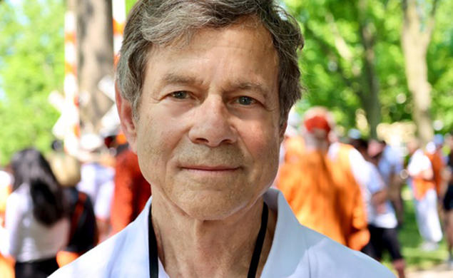 This is a headshot photo of Alan Lightman with Princeton Reunions in the background.