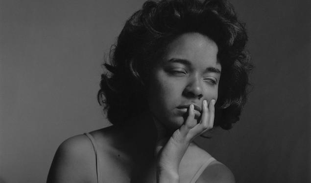 In this black-and-white photo, Carla Williams closes her eyes and rests her chin in her left hand.