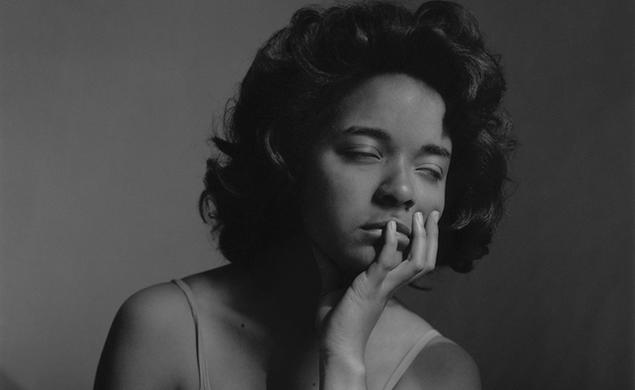 In this black-and-white photo, Carla Williams closes her eyes and rests her chin in her left hand.