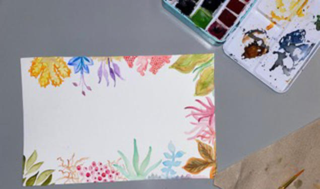 A watercolor painting of flowers reaching in from the edges of the paper.