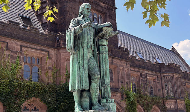 Princeton’s statue of John Witherspoon, turning green outdoors.