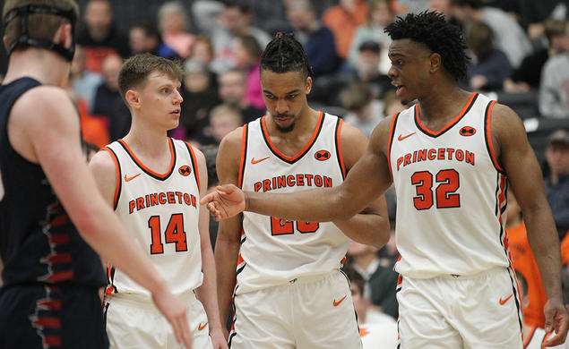 Left to right, Matt Allocco ’24, Tosan Evbuomwan ’23, and Keeshawn Kellman ’23 talking on the court at Jadwin Gym