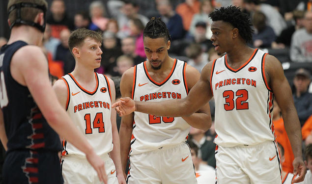 Left to right, Matt Allocco ’24, Tosan Evbuomwan ’23, and Keeshawn Kellman ’23 talking on the court at Jadwin Gym