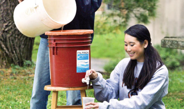 Mechanical and aerospace engineering graduate student Ismaiel Yakub and civil and environmental engineering major Megan Partridge ’14 join forces to demonstrate a ceramic filter system that promises to remove pathogenic bacteria from African drinking wa