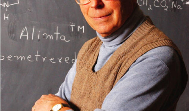  Edward C. Taylor, the A. Barton Hepburn Professor of Organic Chemistry, Emeritus, stands in front of the chemical diagram of Alimta, a powerful cancer-fighting drug that he developed.