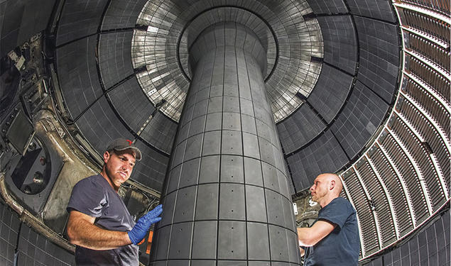 Technicians working inside a fusion device