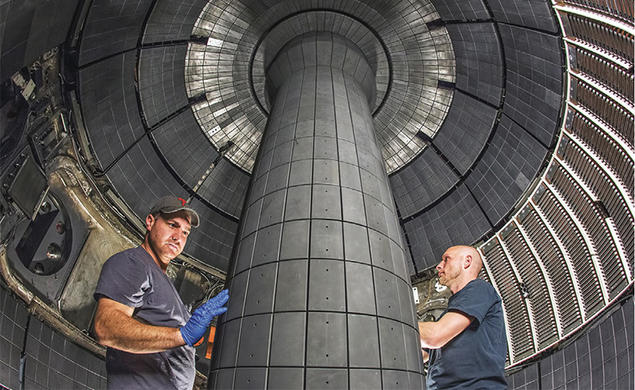 Technicians working inside a fusion device
