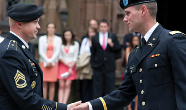 Thomas Boggiano ’12 gets a handshake from Sgt. 1st Class Gregory Bentow after receiving his first salute as an officer.