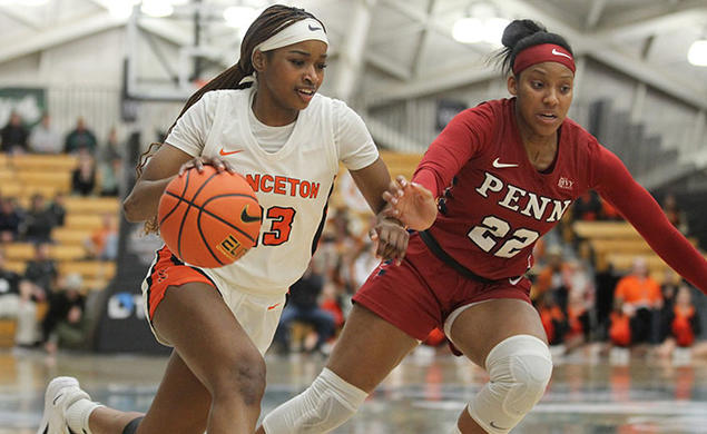 Princeton player dribbles with right hand, Penn defender on her left