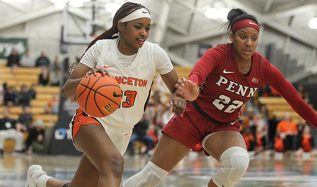 Princeton player dribbles with right hand, Penn defender on her left