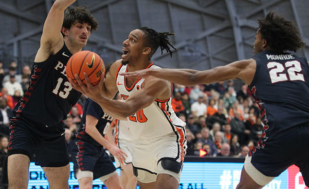 Princeton player Tosan Evbuomwan scoops left-handed shot between two defenders