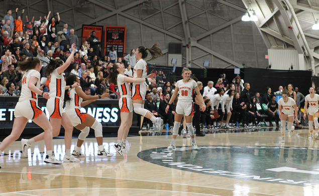 Players celebrating on court with arms raised