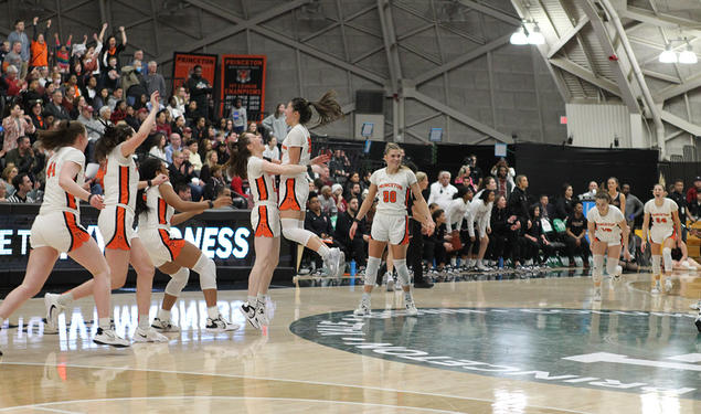 Players celebrating on court with arms raised