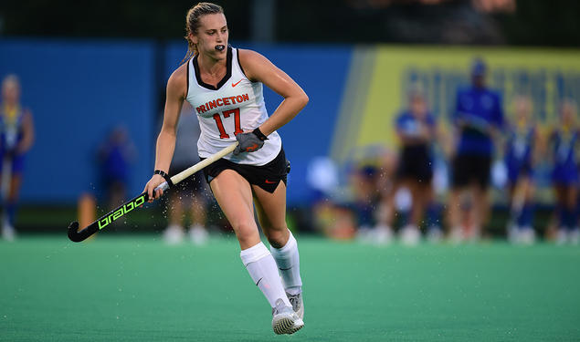 Field hockey player Beth Yeager '26 running and holding hockey stick