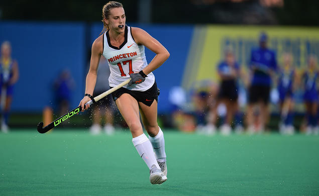 Field hockey player Beth Yeager '26 running and holding hockey stick