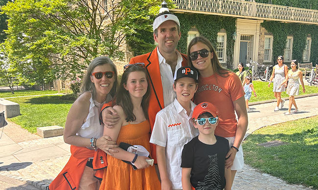 Two parents and their four children, dressed in orange for Princeton Reunions.