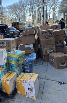 Boxes of supplies are stacked outside on the sidewalk.
