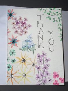 A watercolor painting of flowers with text reading "Thank you."