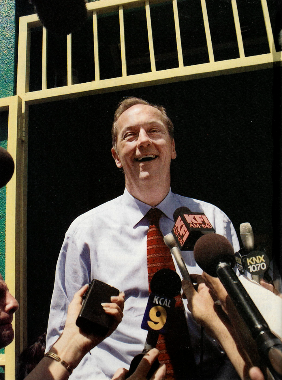 Bradley laughs while speaking to reporters