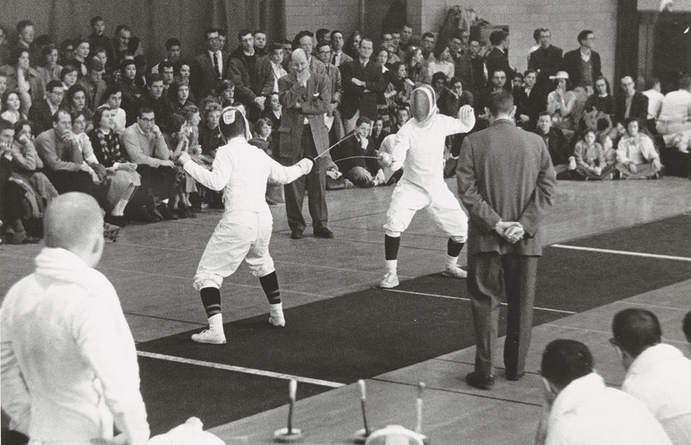 Two fencers face off in this black-and-white photo.