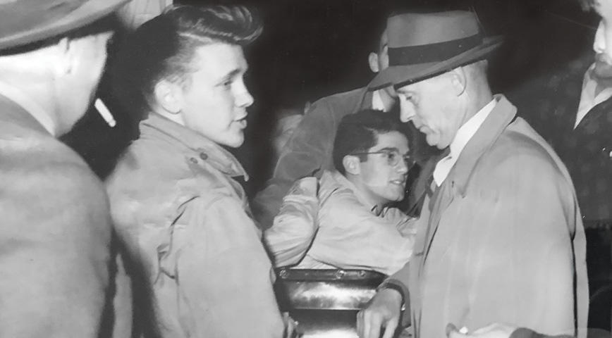 Hats and suits were once standard wear for Princeton proctors. Here, the proctors question visiting students from Penn, circa 1947.