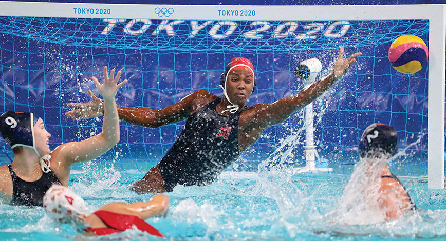 Ashleigh Johnson ’17 jumping out of water to make a goal save during the Tokyo 2021 Olympics