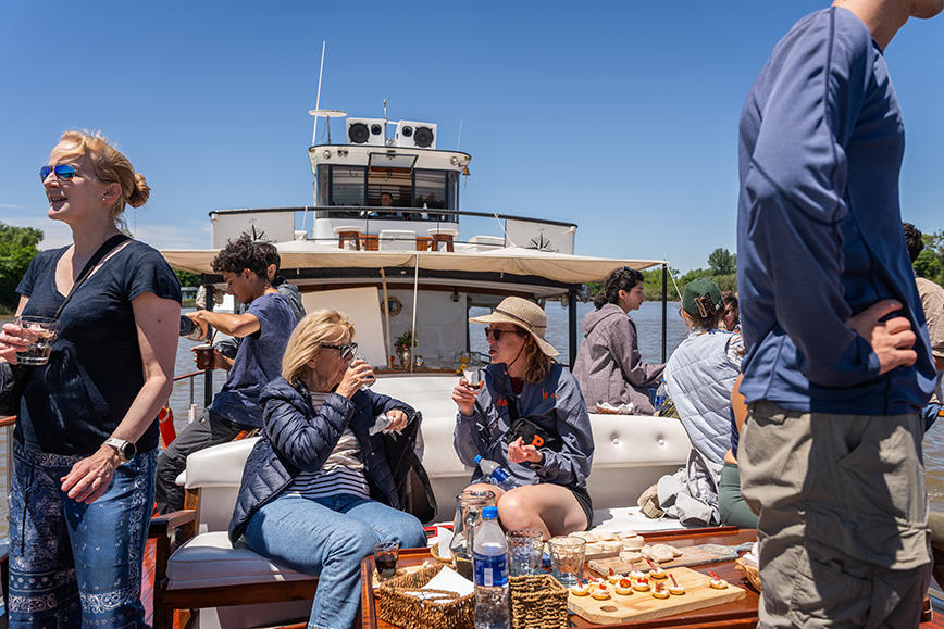 Participants drink coffee and enjoy canapés as they travel along the Tigre Delta.