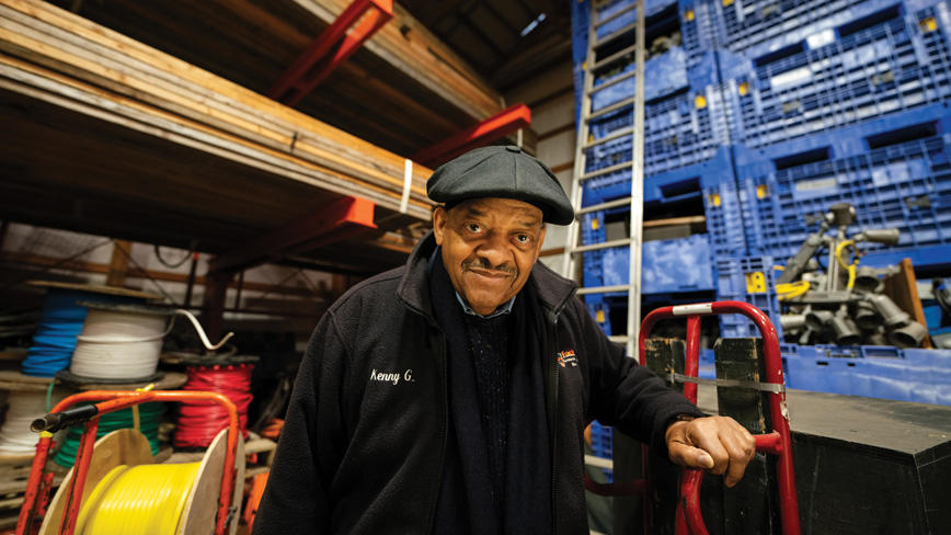 Kenny Grayson, electrical shop supervisor, stands among loads of wire and other electrical hardware