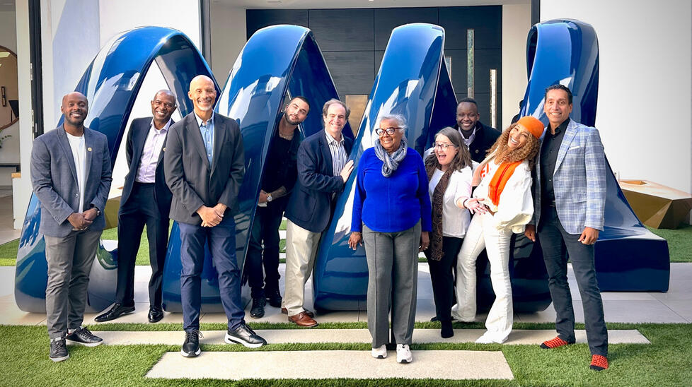 group of Princeton alumni who work with Kwanza Jones &rsquo;93 and Jos&eacute; E. Feliciano &rsquo;94 stand in front of a statue at their Pacific Palisades home