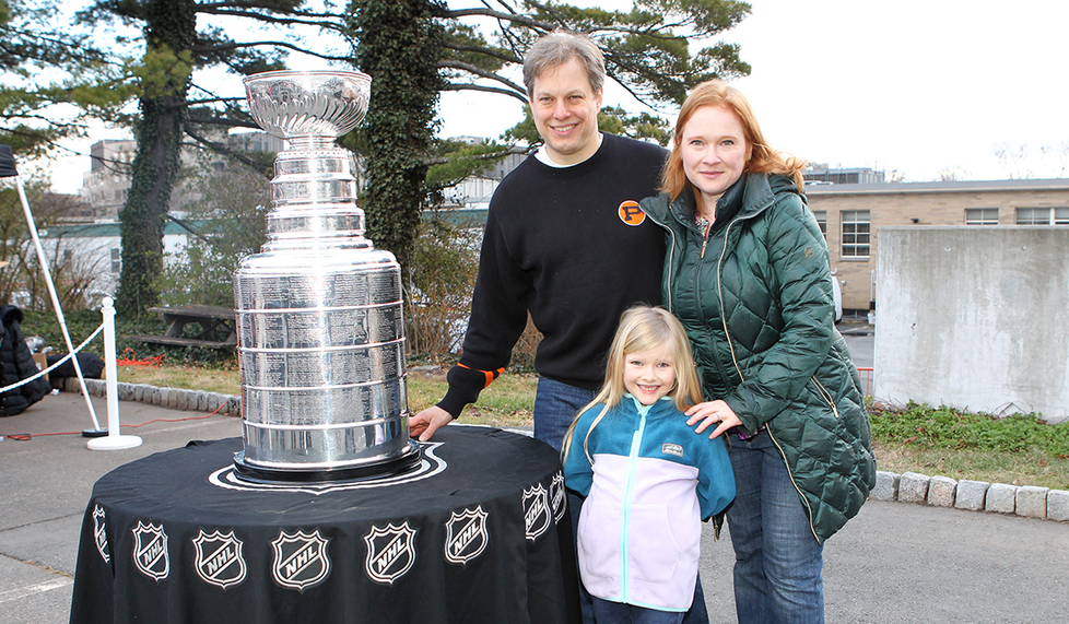 David Mordkoff ’01, Jane Carr ’00, and daughter Charlotte Carr-Mordkoff were among the Princeton fans who posed with the Stanley Cup during Hobey 100 Weekend Jan. 7.