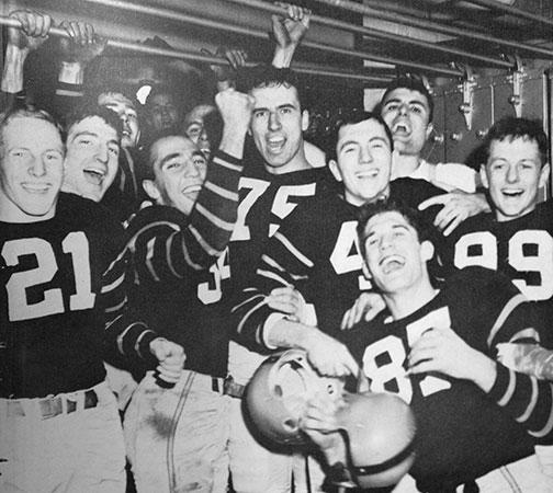 The 1950 Tigers celebrate in the locker room after their win over Yale.